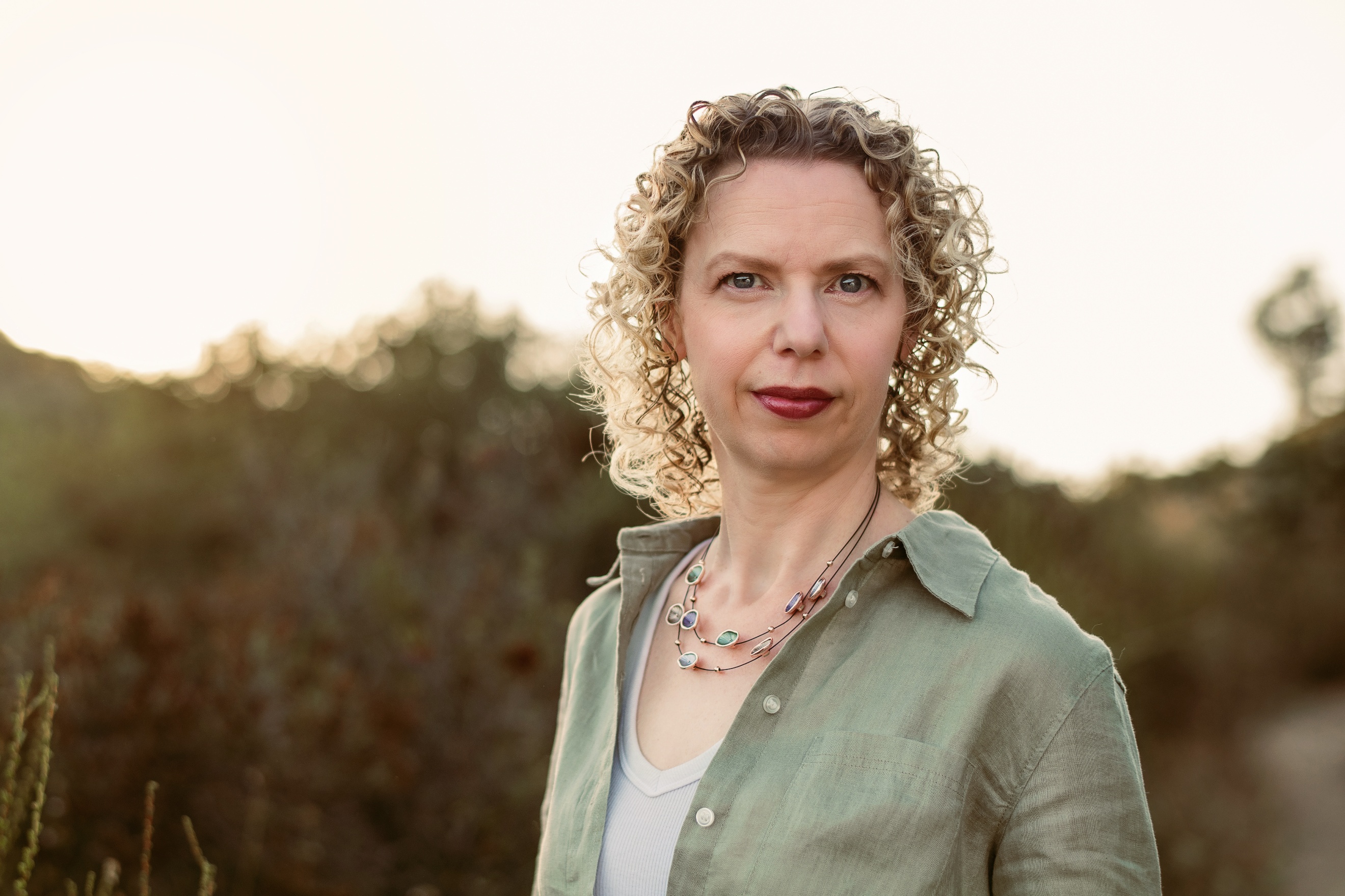 A person with curly hair wearing a green shirt

AI-generated content may be incorrect.